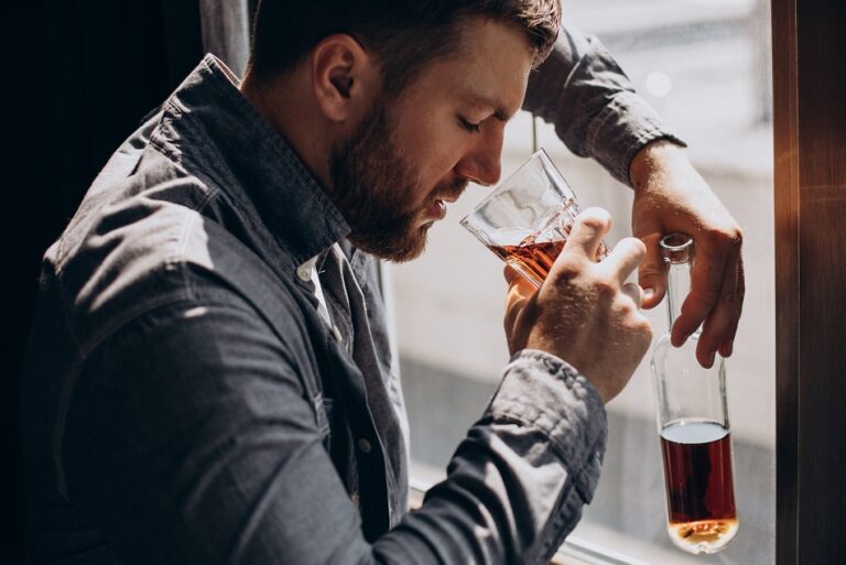 Man drinker depressed with bottle of whiskey