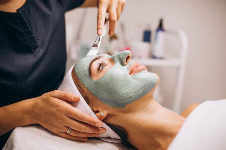 cosmetologist-applying-mask-face-client-beauty-salon