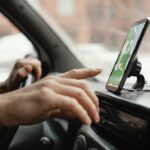 close-up-man-car-with-map-mobile