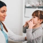 Little patient describing her breathing problem to pediatrician