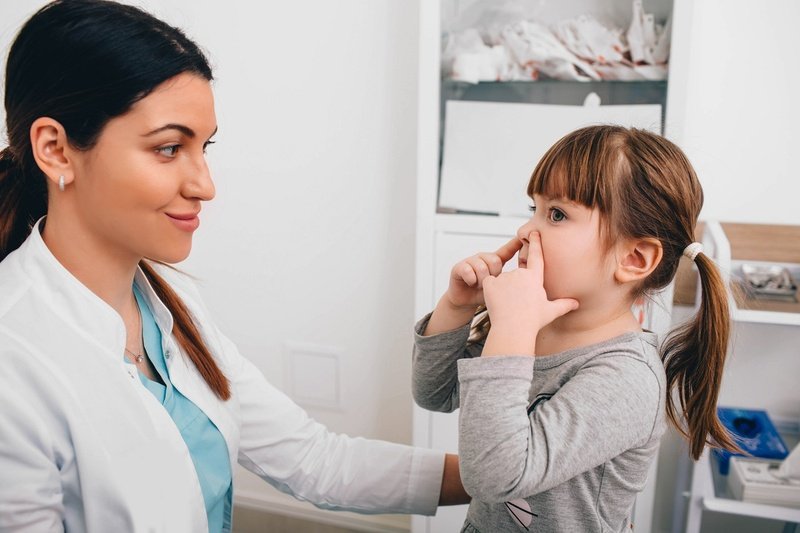 Little patient describing her breathing problem to pediatrician