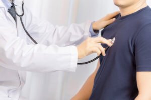 Doctor examination young man with stethoscope in hospital. healt