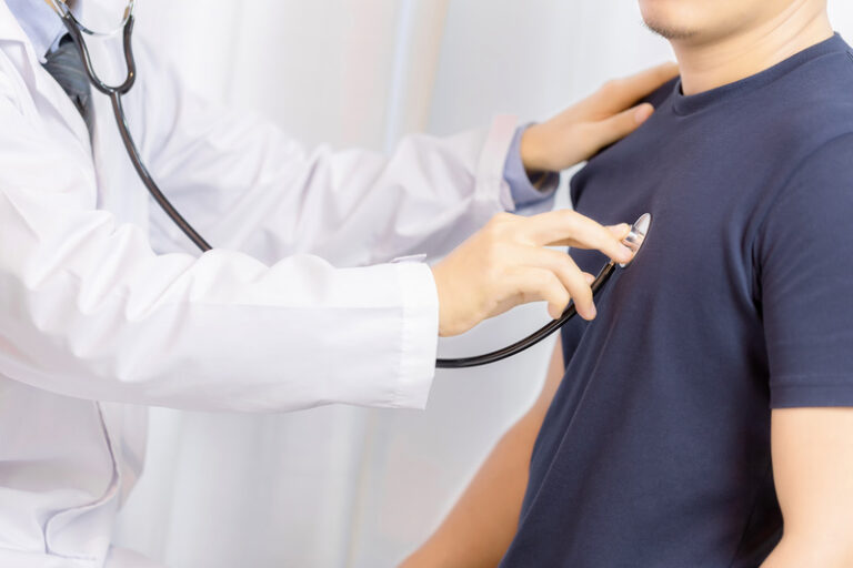 Doctor examination young man with stethoscope in hospital. healt